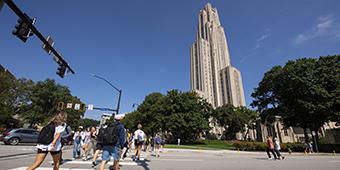 students crossing street toward Cathedral of Learning