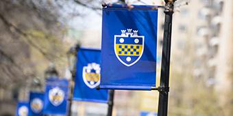 blue banners with Pitt shield hung on lamposts
