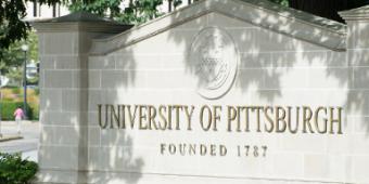 University of Pittsburgh sign on stone wall.